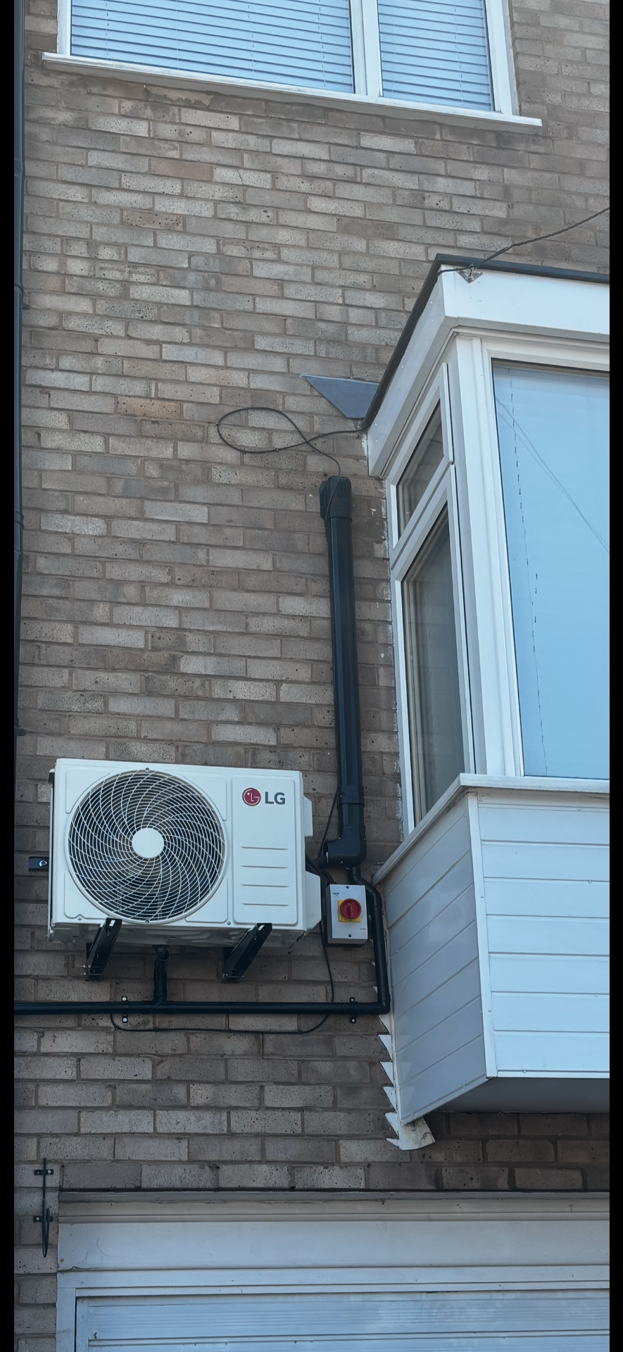 LG outdoor condenser unit neatly wall-mounted on a Halesowen home — the same install standard used on Redditch jobs